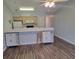 Bright kitchen with wooden cabinets, laminate floors, and breakfast bar with seating at 477 White River Dr. # 32-H, Myrtle Beach, SC 29579