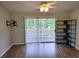 Bright living room featuring hardwood flooring and sliding glass door access to patio at 477 White River Dr. # 32-H, Myrtle Beach, SC 29579