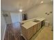 Open-concept space with island sink separating the living room with sliding glass doors at 477 White River Dr. # 32-H, Myrtle Beach, SC 29579