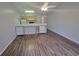 Spacious living room featuring hardwood flooring, a ceiling fan, and natural lighting at 477 White River Dr. # 32-H, Myrtle Beach, SC 29579