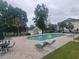 Inviting outdoor pool area with lounge chairs, tables, and a small pool house at 477 White River Dr. # 32-H, Myrtle Beach, SC 29579