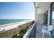 Enjoy ocean views from this condo balcony featuring chairs and views of the beach and blue ocean waters at 4800 S Ocean Blvd. # 504, North Myrtle Beach, SC 29582