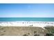 Picturesque beach view with ocean and umbrellas at 4800 S Ocean Blvd. # 504, North Myrtle Beach, SC 29582