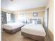 Inviting bedroom features two beds, neutral walls, and a window at 4800 S Ocean Blvd. # 504, North Myrtle Beach, SC 29582