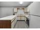 A U-shaped kitchen featuring white cabinets and countertops with a stainless steel sink and black appliances at 500 Fairway Village Dr. # 3-L, Myrtle Beach, SC 29588