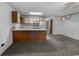 A view of the kitchen with white appliances, a wooden bar, and neutral-colored walls at 500 Fairway Village Dr. # 3-L, Myrtle Beach, SC 29588