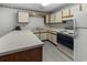 Cozy kitchen with updated white cabinets and countertops with a stainless steel sink and black appliances at 500 Fairway Village Dr. # 3-L, Myrtle Beach, SC 29588