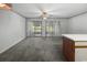 Open-concept living area featuring carpet flooring, light walls, and sliding doors leading to outdoor space at 500 Fairway Village Dr. # 3-L, Myrtle Beach, SC 29588