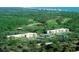 Aerial view of the building, golf course, trees, and coastline at 5001 Little River Rd. # W-211, Myrtle Beach, SC 29577