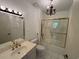 Bathroom with a white sink, chandelier, and glass shower door at 5001 Little River Rd. # W-211, Myrtle Beach, SC 29577