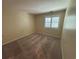 Neutral bedroom with beige carpet, tan walls, and window with white shutters at 5001 Little River Rd. # W-211, Myrtle Beach, SC 29577