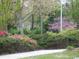 Beautifully landscaped community grounds with vibrant pink azaleas and mature trees at 5001 Little River Rd. # W-211, Myrtle Beach, SC 29577