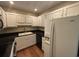 Kitchen featuring white cabinets, stainless steel appliances, and black countertops at 5001 Little River Rd. # W-211, Myrtle Beach, SC 29577