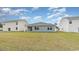 Spacious backyard showcasing a well-maintained lawn, siding, and an adjacent covered patio perfect for outdoor enjoyment at 5141 Yellowstone Dr., Conway, SC 29526