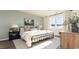 Bright bedroom featuring a black metal bedframe, soft textures, and a large window with natural light at 5141 Yellowstone Dr., Conway, SC 29526
