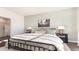 Cozy bedroom with a stylish black metal bed, soft bedding, and an en-suite bathroom at 5141 Yellowstone Dr., Conway, SC 29526