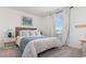 Well-lit bedroom featuring a wicker headboard, soft white bedding, and minimalist decor, creating a serene retreat at 5141 Yellowstone Dr., Conway, SC 29526
