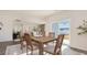 Cozy dining area with a rustic wooden table, stylish chairs, and a sliding glass door to the backyard at 5141 Yellowstone Dr., Conway, SC 29526