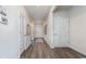 Well-lit hallway with hardwood floors, white doors, and neutral wall paint at 5141 Yellowstone Dr., Conway, SC 29526