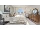 Serene bedroom featuring soft lighting, a comfortable bed, and a large window offering natural light and backyard views at 5141 Yellowstone Dr., Conway, SC 29526