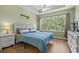 Bright bedroom with a large window, ceiling fan, and coastal decor at 6015 Catalina Dr. # 534, North Myrtle Beach, SC 29582
