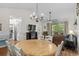 Dining area with chandelier, natural light and seating for six, next to the living room at 6015 Catalina Dr. # 534, North Myrtle Beach, SC 29582