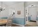 Cozy dining area with wood table, chandelier, and view of the kitchen and entryway at 6015 Catalina Dr. # 534, North Myrtle Beach, SC 29582