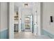 Hallway featuring tile floors, wainscoting, and access to the private balcony at 6015 Catalina Dr. # 534, North Myrtle Beach, SC 29582