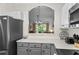 Kitchen view showing stainless steel appliances and view to living area with chandelier at 6015 Catalina Dr. # 534, North Myrtle Beach, SC 29582