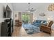 Comfortable living room with cozy seating, ceiling fan, wood flooring, fireplace, and balcony access at 6015 Catalina Dr. # 534, North Myrtle Beach, SC 29582