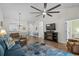 Open living room with fireplace, blue accents, access to dining room, and ceiling fan at 6015 Catalina Dr. # 534, North Myrtle Beach, SC 29582