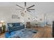 Open living room and dining area with vaulted ceiling, ceiling fan, and a large wall clock at 6015 Catalina Dr. # 534, North Myrtle Beach, SC 29582