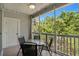 Covered porch features neutral tile flooring, ceiling fan, and white railing overlooking green trees at 6015 Catalina Dr. # 534, North Myrtle Beach, SC 29582