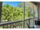 Expansive green tree view on a screened in porch with a table and chairs set on neutral tile at 6015 Catalina Dr. # 534, North Myrtle Beach, SC 29582
