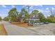 This exterior view offers a street view, with ample parking, landscaping, and architectural details at 6501 Somerset Dr., Myrtle Beach, SC 29572