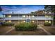 Two-story apartment building with a brick facade and gray siding, illuminated in the evening at 6501 Somerset Dr., Myrtle Beach, SC 29572