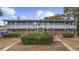 Two-story apartment building with a brick facade and gray siding, surrounded by mature landscaping at 6501 Somerset Dr., Myrtle Beach, SC 29572