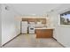 Kitchen featuring white appliances and wooden cabinets, open to living space at 6501 Somerset Dr., Myrtle Beach, SC 29572