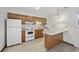 Kitchen featuring wooden cabinets and breakfast bar, with appliances and natural light at 6501 Somerset Dr., Myrtle Beach, SC 29572