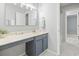 Neutral bathroom vanity with large mirror, updated lighting, and tiled floors at 6703 Jefferson Pl. # B7, Myrtle Beach, SC 29572