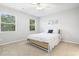 Bright bedroom features neutral walls, carpet, ceiling fan and natural light from two windows at 6703 Jefferson Pl. # B7, Myrtle Beach, SC 29572