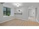 Bright dining area shows a window and leads to the kitchen with a white door that goes to the outside at 6703 Jefferson Pl. # B7, Myrtle Beach, SC 29572