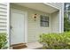 Welcoming entryway with a white door, a 'Welcome' mat, and a decorative exterior light fixture at 6703 Jefferson Pl. # B7, Myrtle Beach, SC 29572
