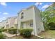 Charming two-story townhouse featuring light green siding, manicured bushes, and a well-maintained lawn on a sunny day at 6703 Jefferson Pl. # B7, Myrtle Beach, SC 29572