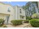 Inviting townhouse featuring a stucco exterior, a manicured lawn, and lush greenery at 6703 Jefferson Pl. # B7, Myrtle Beach, SC 29572