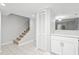 Hallway view with a staircase, closet, and connection to kitchen with modern lighting at 6703 Jefferson Pl. # B7, Myrtle Beach, SC 29572