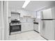 Bright kitchen with stainless steel appliances, white cabinets, and a hexagon tile backsplash at 6703 Jefferson Pl. # B7, Myrtle Beach, SC 29572