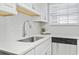 Close-up of a kitchen sink with quartz countertops, stainless steel faucet, and stainless steel dishwasher at 6703 Jefferson Pl. # B7, Myrtle Beach, SC 29572