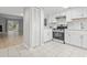 Open concept kitchen with white cabinets, stainless steel appliances, and access to the living area at 6703 Jefferson Pl. # B7, Myrtle Beach, SC 29572