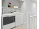Upstairs laundry area with modern washer and dryer appliances and wire shelving at 6703 Jefferson Pl. # B7, Myrtle Beach, SC 29572